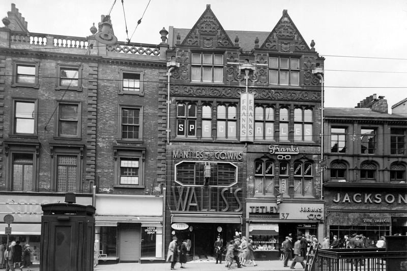 Briggate in August 1946. Shops in view include Saxone and Sorosis Shoe Co Ltd, Wallis and Co. (costumiers) Ltd, Tetley and Sons Ltd, tobacconists and Franks (opticians) Ltd and  Jackson the tailor.
