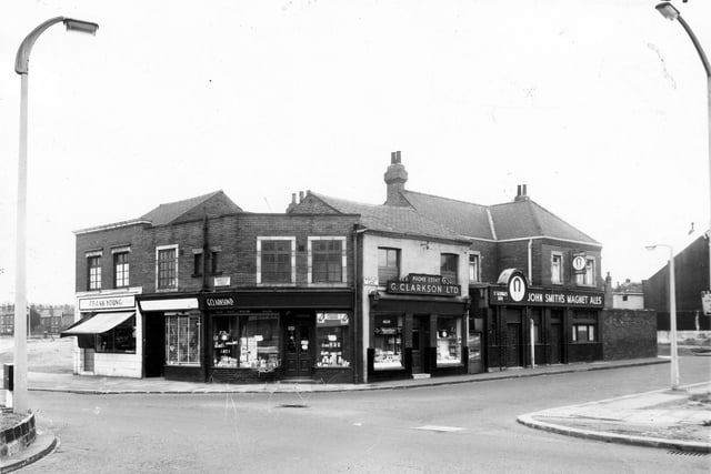The junction of Domestic Street and Wortley Lane in  March 1965. On the left is Frank Young, butcher on Domestic Street followed to the right by L. Roberts, drapers. Continuing right is a Clarkson Ltd on Wortley Lane, this is a chemists. The St George's Inn is on the right.