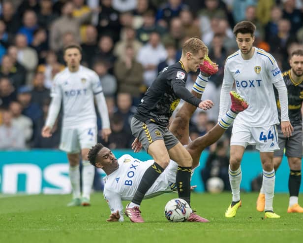 FORTUNATE: Leeds United defender Junior Firpo, pictured tumbling left behind Southampton's Flynn Downes, not to see red. Picture by Tony Johnson.