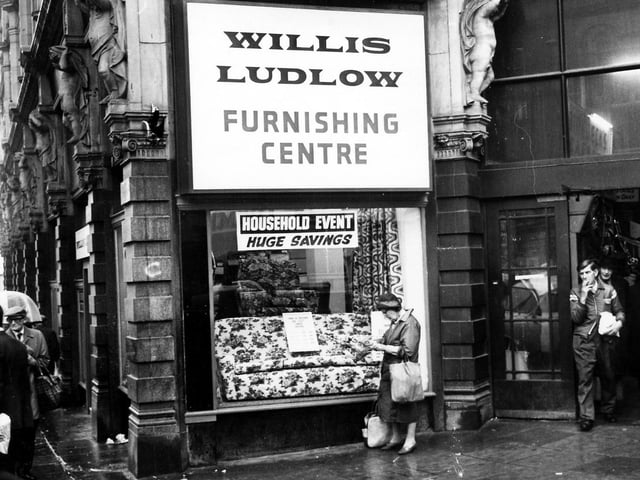 The shop window of the Willis Ludlow department store, displaying sofas and chairs and advertising 'huge savings' in January 1979.
