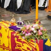 King Charles III in front of the coffin of Queen Elizabeth II during her State Funeral at the Abbey in London