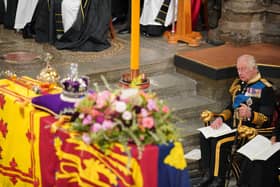 King Charles III in front of the coffin of Queen Elizabeth II during her State Funeral at the Abbey in London
