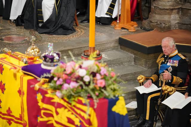 King Charles III in front of the coffin of Queen Elizabeth II during her State Funeral at the Abbey in London