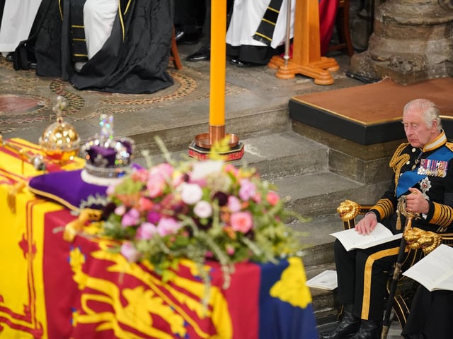 King Charles III in front of the coffin of Queen Elizabeth II during her State Funeral at the Abbey in London