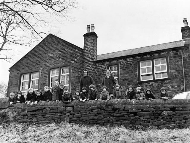 Children of the closure-threatened Scammonden School are pictured with their headteacher Mrs. J. Busfield and her assistant Mrs. J. David in March 1970.