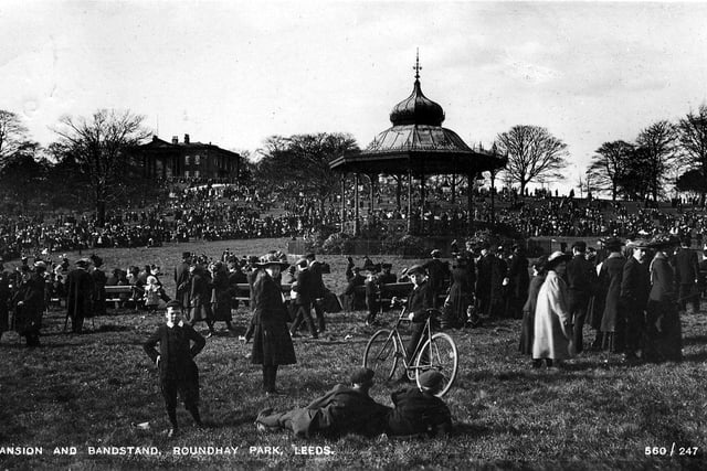 An undated postcard view showing a crowded Roundhay Park with the bandstand in the centre and the Mansion in the background on the left.