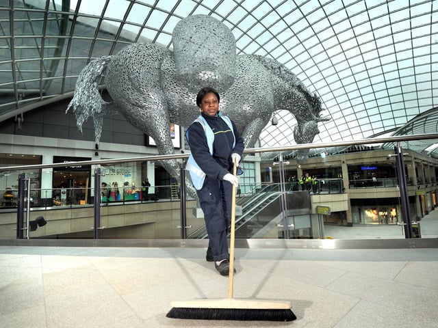 Cleaner Patience Ahema does some last minute sweeping ahead of the opening.