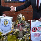 Leeds chief executive Angus Kinnear (L) and Liverpool chief executive Billy Hogan (R), exchange pennants in front of the commemorative plaque honouring Leeds supporters Christopher Loftus and Kevin Speight, to mark the 34th anniversary of the Hillsborough Disaster (Photo by OLI SCARFF/AFP via Getty Images)