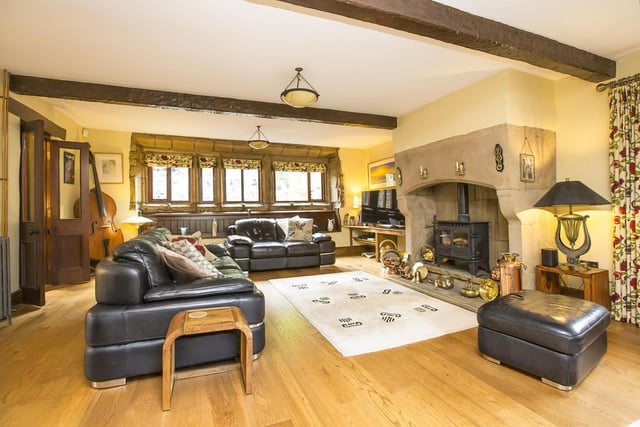 A huge Inglenook fireplace is a centrepiece  in the spacious lounge with exposed stone walls.