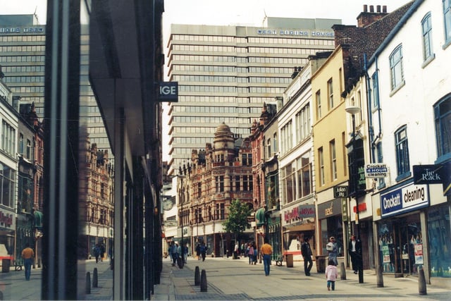 Commercial Street looking west from the direction of Briggate. The tree stands at the junction with Lands Lane. West Riding House dominates the background and is located on Albion Street.