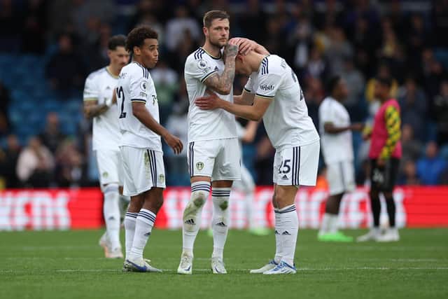 'HEART-BREAKING': Defeat for Leeds United against Arsenal on Sunday as Whites captain Liam Cooper consoles Rasmus Kristensen and Tyler Adams, left, looks on.
Photo by Eddie Keogh/Getty Images.
