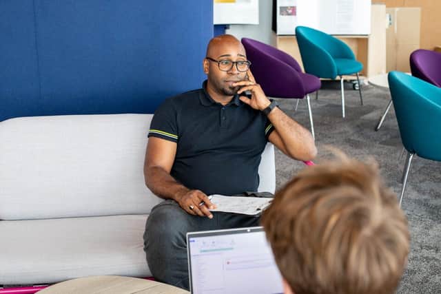 A man talks to a financial navigator about his money management and wellbeing
