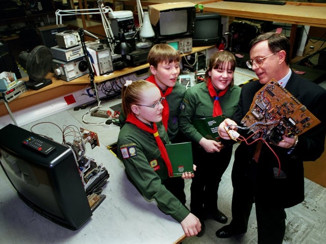 Scouts from the 8th South Leeds (Carlton Group) during a visit to the Comet Customer Service Centre in Leeds in March 1998. The retailer was sponsoring the Scout Electronics Badge and distributing training packs for every Scout Group in the UK. Pictured, from left, are Holly Peters, Chris Brown, Vikki Patterson and quality assurance manager Stewart Price.