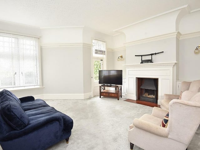 A carpeted reception room with a glazed door giving access to the garden.