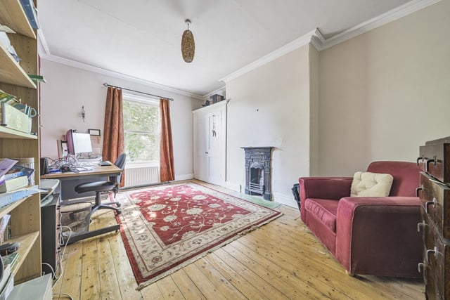 Located at the rear of the property, this large double bedroom has a feature cast iron fire surround.