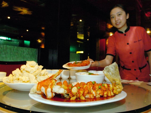 Did you enjoy a meal here back in the day? Red Chilli restaurant in Leeds city centre. Pictured is Soo Chen Teh carrying a Saute king prawn dish, pictured with the Crispy yellow cracker with sweet and sour sauce, assorted seafood and served with rice crisps.