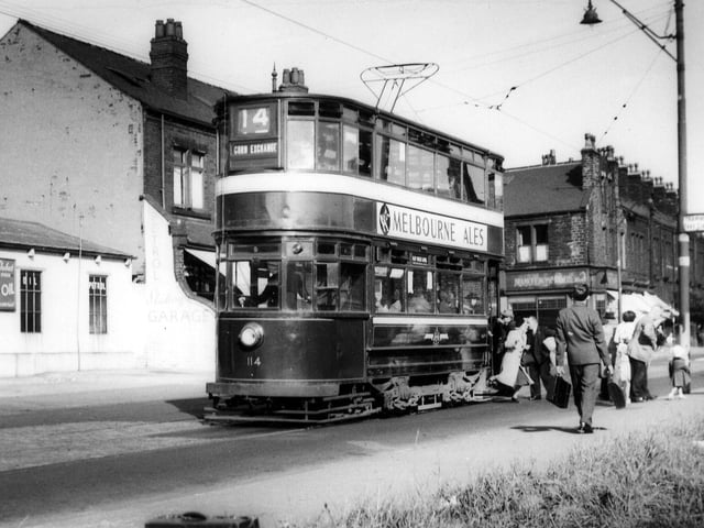Passengers alighting from tram no.114 at a stop on Stanningley Road in August 1952. The Station Garage is on the left. To the right of the tram is Bramley Home Bakeries at the junction with Hough Lane. Tram no.114 was a Chamberlain which ran in service between November 16, 1926 and February 10, 1955. It is here on route 14 displaying the destination 'Corn Exchange', presumably in readiness for turning round to make the return journey to the city centre.