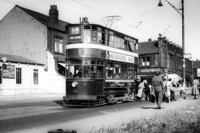 Passengers alighting from tram no.114 at a stop on Stanningley Road in August 1952. The Station Garage is on the left. To the right of the tram is Bramley Home Bakeries at the junction with Hough Lane. Tram no.114 was a Chamberlain which ran in service between November 16, 1926 and February 10, 1955. It is here on route 14 displaying the destination 'Corn Exchange', presumably in readiness for turning round to make the return journey to the city centre.