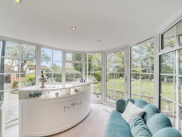 From the sitting room, French doors lead into a delightful conservatory overlooking the garden, offering a tranquil retreat to enjoy the views across the landscaped grounds.