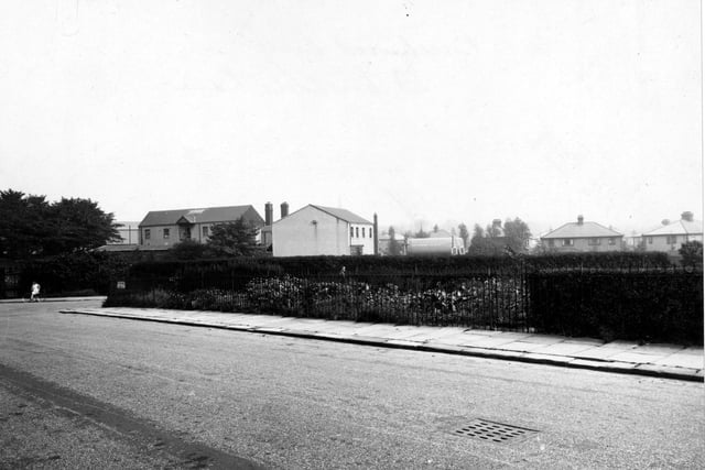 Looking east at the junction of St. Michael's Lane and Beechwood Crescent in August 1948.  On the left is a girl on a bicycle.