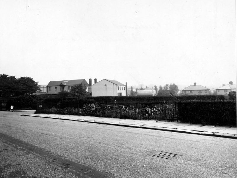 Looking east at the junction of St. Michael's Lane and Beechwood Crescent in August 1948.  On the left is a girl on a bicycle.