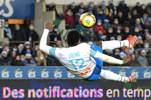 Marseille's Senegalese forward Bamba Dieng shoots to score his team's first goal during the French L1 football match between RC Strasbourg Alsace and Olympique de Marseille (OM) at Stade de la Meinau in Strasbourg, eastern France on December 12, 2021. (Photo by SEBASTIEN BOZON / AFP) (Photo by SEBASTIEN BOZON/AFP via Getty Images)