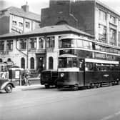 Tram 534 pictured on Wellington Street on route 534 to Cross Gates. Number 42 bus to Lower Wortley can also be seen. Pictured in September  1954.