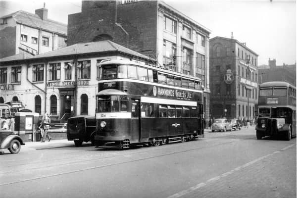 Tram 534 pictured on Wellington Street on route 534 to Cross Gates. Number 42 bus to Lower Wortley can also be seen. Pictured in September  1954.