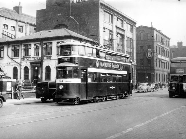 Tram 534 pictured on Wellington Street on route 534 to Cross Gates. Number 42 bus to Lower Wortley can also be seen. Pictured in September 1954.