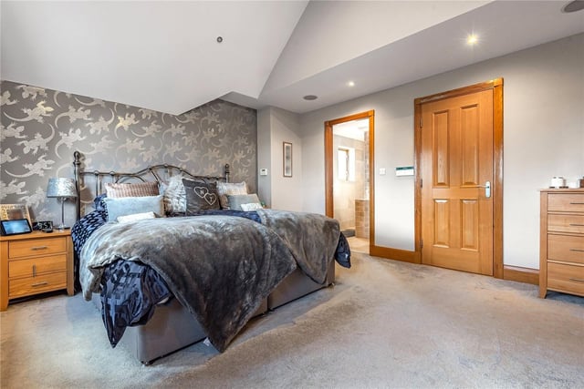 The main suite boasts a large walk-in wardrobe and a luxurious en-suite shower room