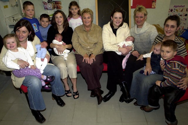 Retiring Farsley clinic midwife Christine Kettlewell (centre) with some of the babies she has helped with. Pictured in October 2003.