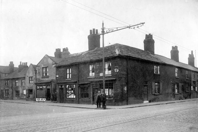 The junction with Low Road and Church Street in August 1929. Alfred Hartley,  fried fish shop has a tram stop outside and a gas lamp fitted to the wall.