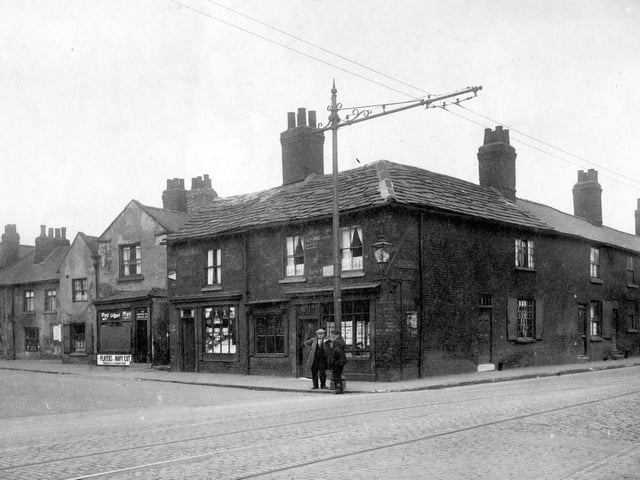 The junction with Low Road and Church Street in August 1929. Alfred Hartley,  fried fish shop has a tram stop outside and a gas lamp fitted to the wall.