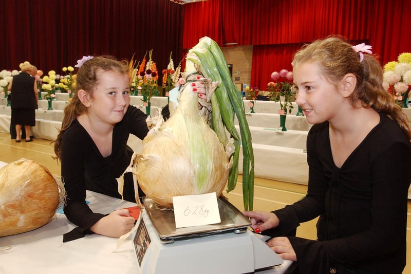 Makala and Chantelle Sleightholme admire a prize-winning onion at the 2005 Sunderland Horticultural Show.