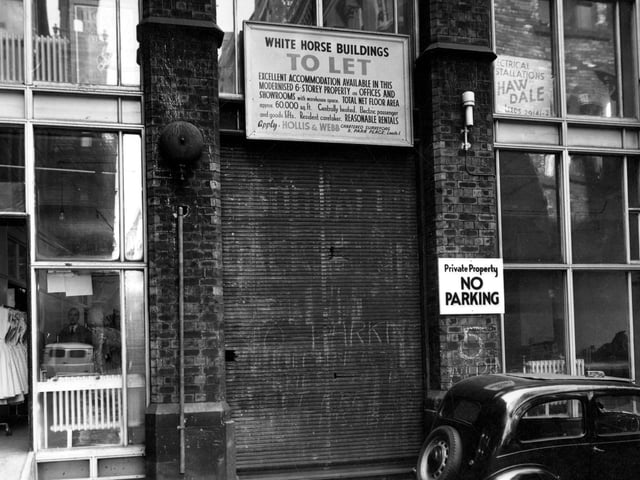 The White Horse Buildings on White Horse Street, which are To Let. Advertising board states that property is six storeys high and has been modernised. The total net floor area is 60,000 square feet. Interior of shop to left can be seen, showing a rail of ladies dresses. Pictured in July 1955.