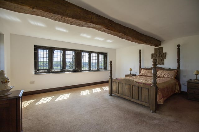 This beamed double bedroom has mullion windows with views that stretch for miles.