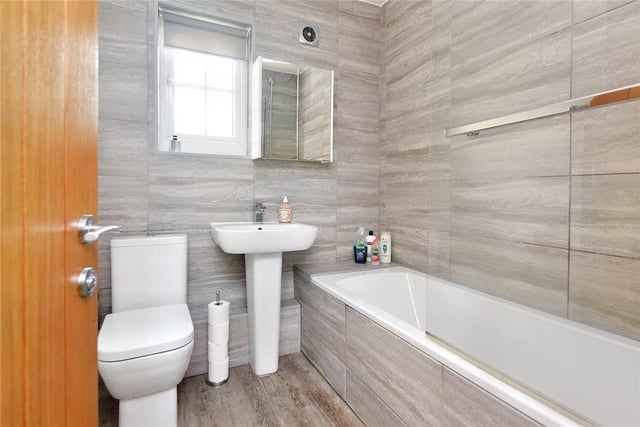 The bathroom is attractively fitted with a white three piece suite.
