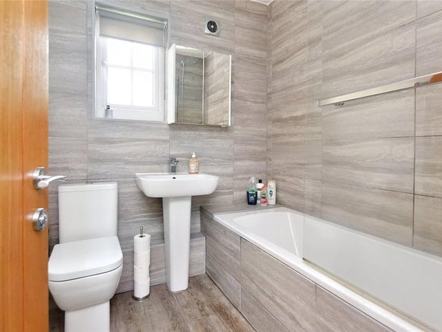 The bathroom is attractively fitted with a white three piece suite.