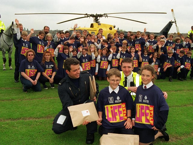 Around 60 pupils at Garforth Community College were due to take part in the Lifestyle 98 project, a summer scheme set up by the police to give youngsters a focus on their communities during school holidays. Here, at front, PC Shaun Daniel, of the West Yorkshire Air Support Unit, together with PC Mark Gee, Community Constable for Garforth, hand out the project packs and t-shirts to William Beaty and Cassie Goodall and the rest of the pupils.