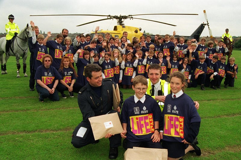 Around 60 pupils at Garforth Community College were due to take part in the Lifestyle 98 project, a summer scheme set up by the police to give youngsters a focus on their communities during school holidays. Here, at front, PC Shaun Daniel, of the West Yorkshire Air Support Unit, together with PC Mark Gee, Community Constable for Garforth, hand out the project packs and t-shirts to William Beaty and Cassie Goodall and the rest of the pupils.