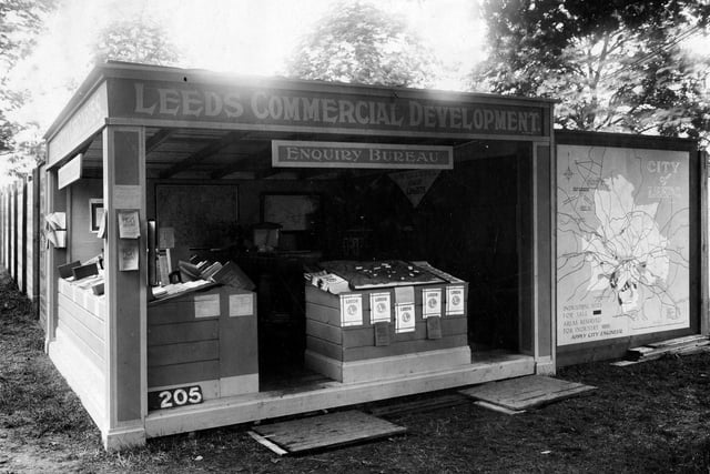 A view of Library Stand at Yorkshire show in July 1932. Stand has sign, reads 'Leeds Commercial development , enquiry bureau'.