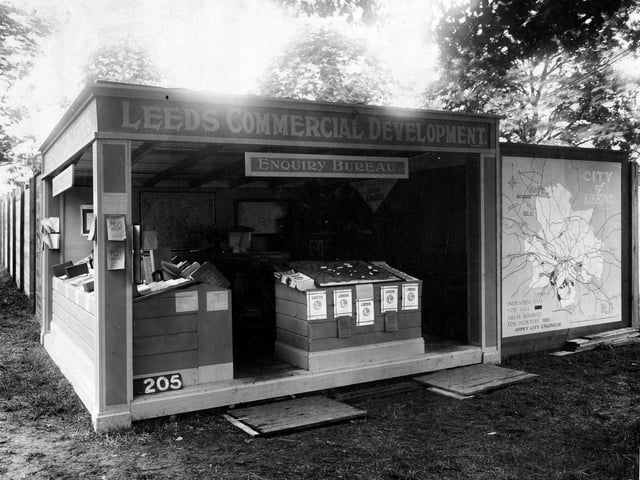 A view of Library Stand at Yorkshire show in July 1932. Stand has sign, reads 'Leeds Commercial development , enquiry bureau'.