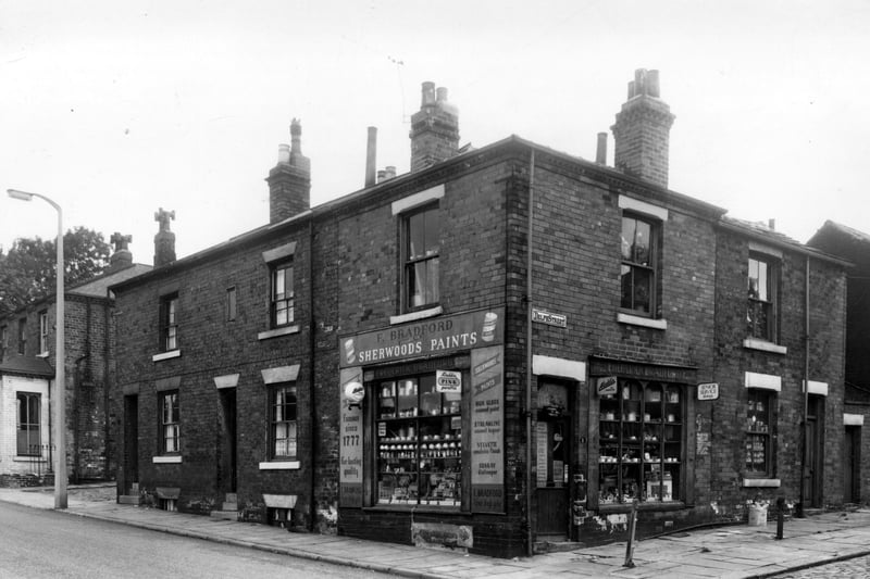 Woodhouse Street in September 1959. On the left is no.212. This house, with the white painted bay window, is at the corner with Ebury Street. Next, two houses nos. 210 & 208, then 206, which is at the junction with Delph Street. This shop was the business of Frederick Bradford, with the slogan 'I can help you!' A vast array of goods are on offer, including paint, electrical, television and radio, DIY supplies, paraffin and household goods. On the right is 3 Delph Street. This was part of the shop premises.