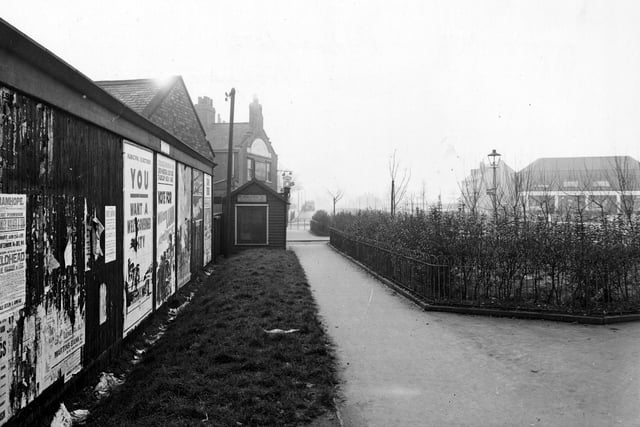 A footpath near Cross Gates Ring Road in January 1946. To the left is a wall covered with posters for the forthcoming municipal elections. Travellers Rest pub can be seen further on. On the right is a small garden enclosed by iron railings.