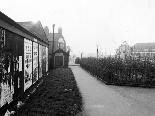 A footpath near Cross Gates Ring Road in January 1946. To the left is a wall covered with posters for the forthcoming municipal elections. Travellers Rest pub can be seen further on. On the right is a small garden enclosed by iron railings.