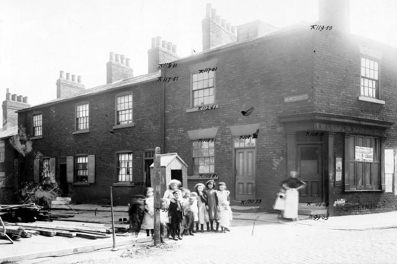 The junction of Waterloo Street with Wales Avenue in 1904. A group of children and women with child stand on the corner. The premises of T.W. Chaplin, hairdresser is on corner with notice stating that the business is now being conducted 4 doors down.