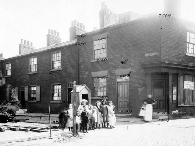 The junction of Waterloo Street with Wales Avenue in 1904. A group of children and women with child stand on the corner. The premises of T.W. Chaplin, hairdresser is on corner with notice stating that the business is now being conducted 4 doors down.