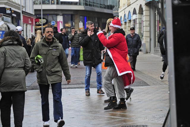 Christmas shoppers go about their business including one dressed as the big man himself.