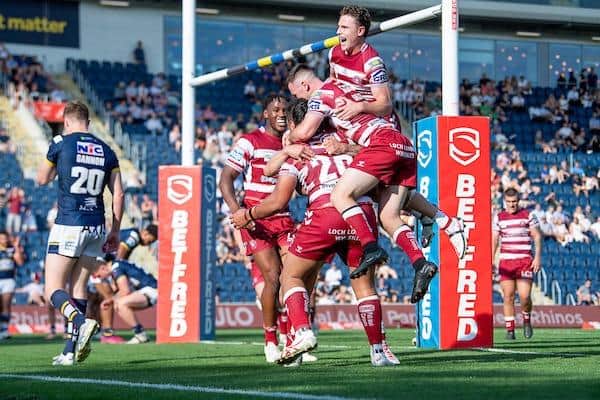 Wigan celebrate Patrick Mago's converted try whichtook them to 50 points and left Rhinos fans embarrassed. Picture by Allan McKenzie/SWpix.com.