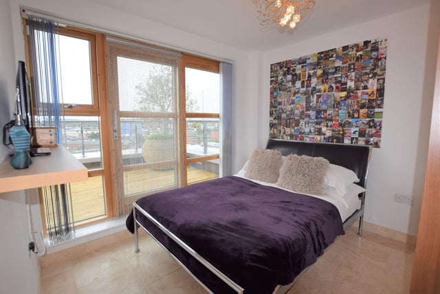 Double bedroom with large fitted wardrobe, wooden framed double glazed window with sliding door leading to the terrace.